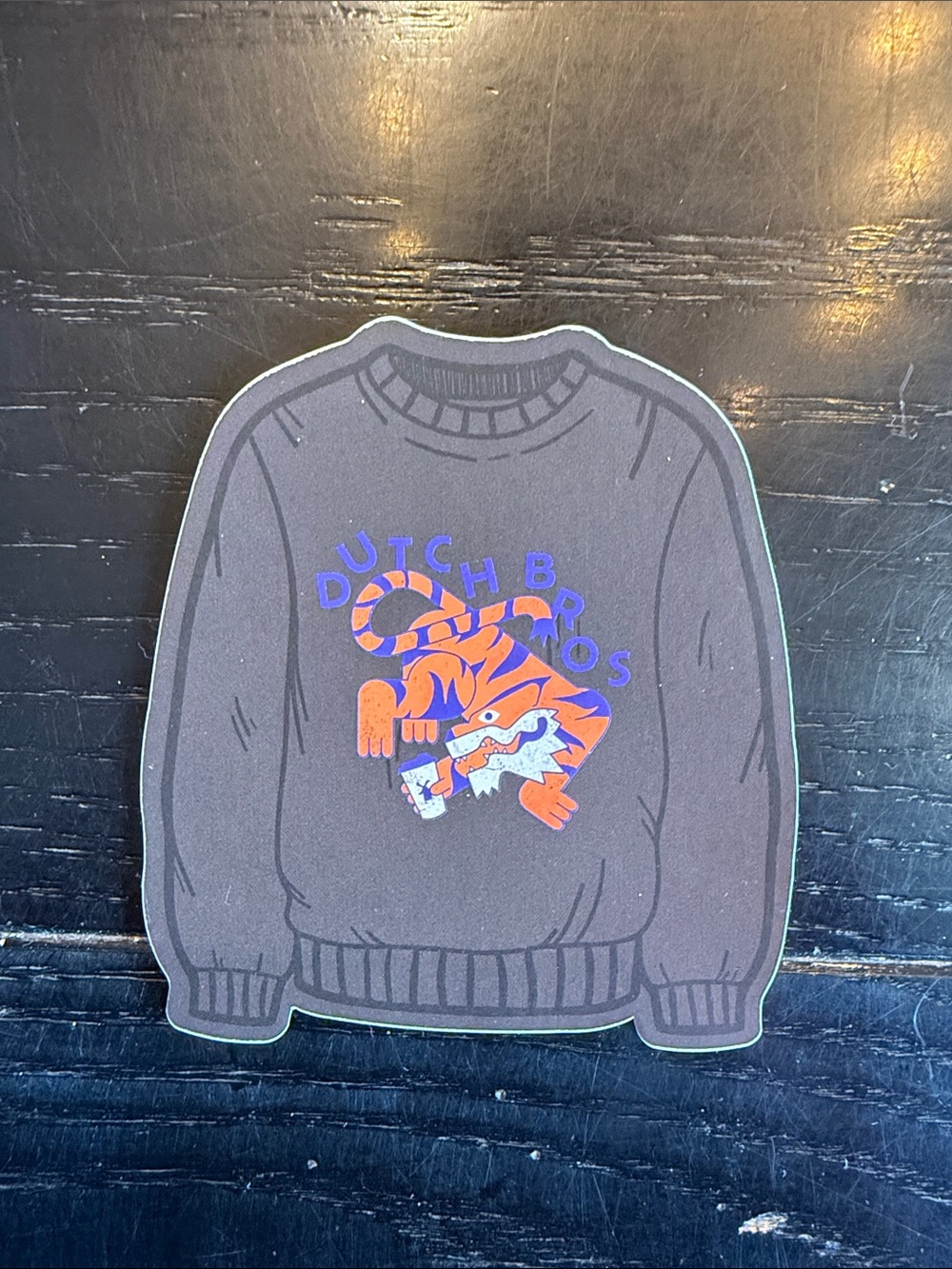 Dutch Bros dark gray sticker with orange and blue tiger design